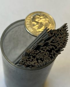 dozens of 1mm od core drills in a plastic cup